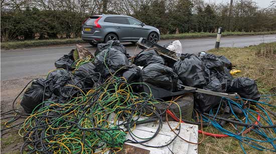 Fly tipped rubbish by road