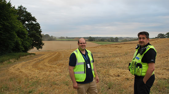 PCC in corn field with police officer